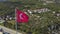 Panorama of Alanya resort city with residential complex on a summer sunny day. Clip. Aerial view of a red Turkey flag