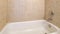Panorama Alcove bathtub close up with brown ceramic tiles surround