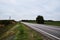 Panorama along a deserted road. Straight road through the fields.