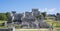 Panorama of the ancient Mayan building ruins against blue sky in