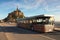 Panorama of ancient Mont Saint Michele abbey in a beautiful spring morning. Special bus brought first tourists to the Abbey.