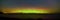 Panorama aurora lights and starry sky over great lake or ocean with dark shore at night