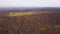 Panorama of autumn bare forest with stones. Clip. Top view of forested autumn hills with stones of destroyed mountains