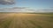 Panorama autumn field and combine against sky with clouds