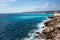 Panorama. Azure sea, waves, English promenade and people resting. Rest and relaxation by the sea. On a sunny warm day, blue waves