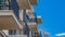 Panorama Balconies of a residential building against blue sky and snowy mountain