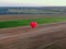 Panorama of balloon flight from altitude in summer in good weather over the field and houses