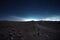 panorama of a barren landscape under a vast night sky