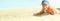 Panorama of the beach view with copyspace and happy child boy lying on sand