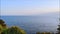Panorama of the beautiful blue Mediterranean sea in calm with shore with green trees