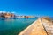 Panorama of the beautiful old harbor of Chania with the amazing lighthouse, mosque, venetian shipyards, at sunset, Crete.