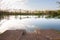 Panorama of bela crkva lakes at dusk with calm water and sunny sky.