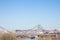 Panorama of Belgrade landscape seen from Sava river, with a Beovoz train passing on a railway bridge in front.