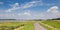Panorama of a bicycle path along the river Waal