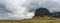 Panorama of the big and famous moss covered cliff formation Lomagnupur in Iceland. Powerlines in the background.