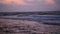 Panorama on big waves and vivid cloudscape at sunset