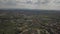 Panorama from a bird`s eye view. Central Europe: town or village is located among the green hills. Temperate climate. Flight dron
