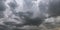 Panorama of black sky background with storm clouds. thunder front