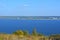 Panorama with blue river and town on the opposite bank. Sunny september day