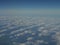 Panorama of blue sky and cloud as seen through window of an aircraft above Europe