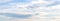 Panorama of blue sky with white long clouds in calm pastel colors