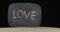 Panorama of a board with the inscription LOVE sticking out in the sand. Concept. Isolated