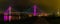 Panorama of Bob Kerrey pedestrian bridge Omaha Nebraska at night with multiple light reflections in the Missouri river.