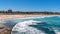 Panorama of Bondi beach on a hot sunny summer day with blue sky in Sydney Australia