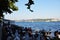 Panorama of the Bosphorus. View of the crowded cafe on the embankment of the strait.