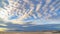 Panorama Boundless blue sky with gray and white clouds over a vast sandy shore