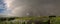 Panorama of a bright colorful rainbow over the dutch countryside