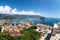 Panorama of Budva Riviera with city, old town with fortified walls and red roofs. View from above, wide angle. Adriatic sea,