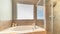 Panorama Built in circlar bathtub deside a shower stall inside the bathroom of a home