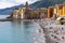 Panorama of the Camogli coast and beach with people.