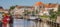 Panorama of a canal with old ships and historical houses in Zwolle