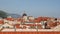 Panorama of the city of Dubrovnik, from the walls of the old city. Camera wiring on tiled roofs.