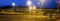 Panorama of city highway in dusk with blurred headlights