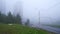 Panorama in city of houses and cars in dense fog in summer in slow motion