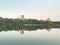 Panorama of the city park. Modern high-rise buildings. Reflection in the city lake.