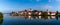 Panorama cityscape of Ptuj with the hilltop castle and reflections in the Drava River