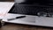 Panorama, close-up of desktop, laptop, pen and glasses.