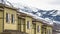 Panorama Close up of facade of townhomes with snowy mountain and cloudy sky background