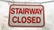 Panorama Close up of sign that reads Stairway Closed against snow covered slope in winter