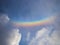 Panorama cloudscape view of natural colorful rainbow with white clouds and blue sky in Rotterdam Netherlands Europe