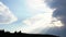 Panorama of cloudy sky with sun and shadow of forest. Media. Overcast clouds with rays of daytime sun on blue sky