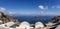 Panorama of the coast on the island of Santorini caldera in Greece. The background is a blue sky with white clouds