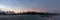 Panorama ,Coconut trees and trees separating the beach `Chao Samran` and the road , Sky in the evening after sunset