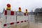 Panorama of Cologne with cathedral and hohenzollern bridge at snowy weather. rhine river with high water, barrier with warning