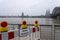 Panorama of Cologne with cathedral and hohenzollern bridge at snowy weather. rhine river with high water, barrier with warning
