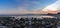 Panorama of a colorful sunset on the Mediterranean Sea in Almeria with rocks and tidal pools in the foreground